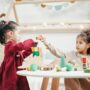 Children doing fun craft activities together at a table with art supplies